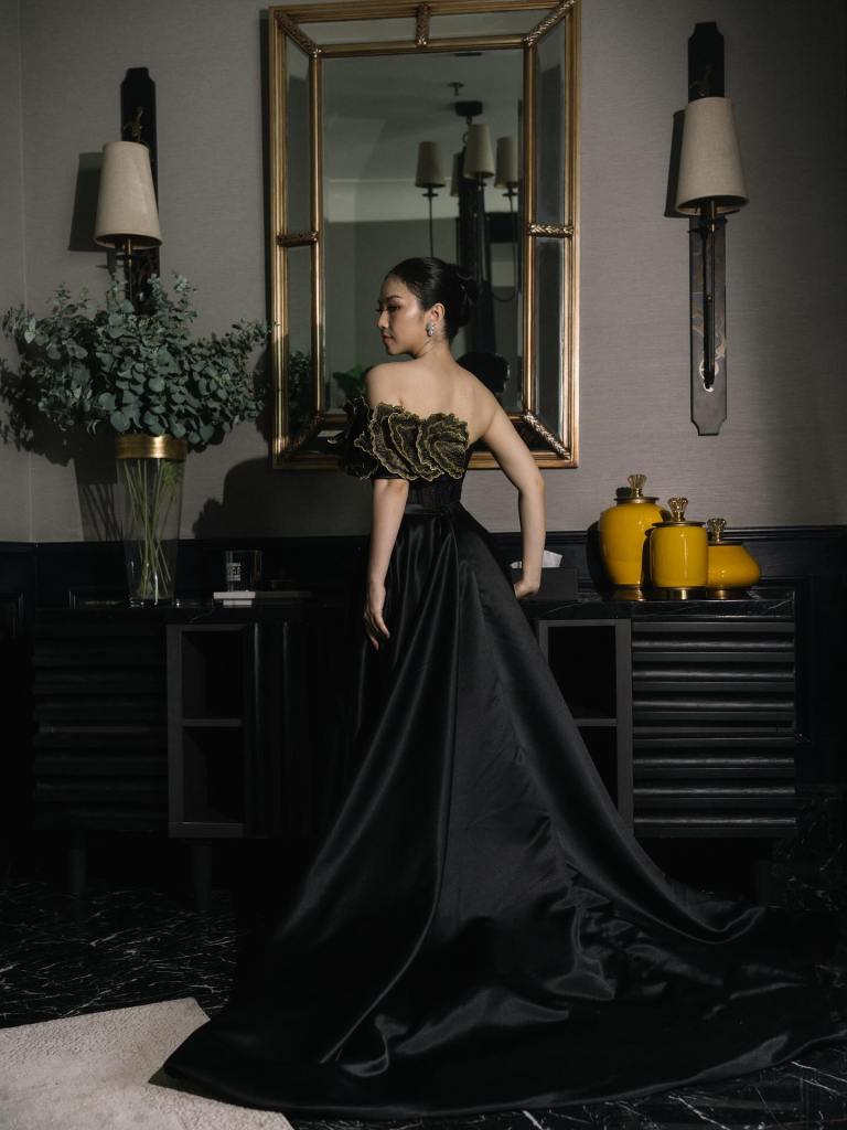 CELRA black satin evening gown with sculptural gold bodice, seen from behind