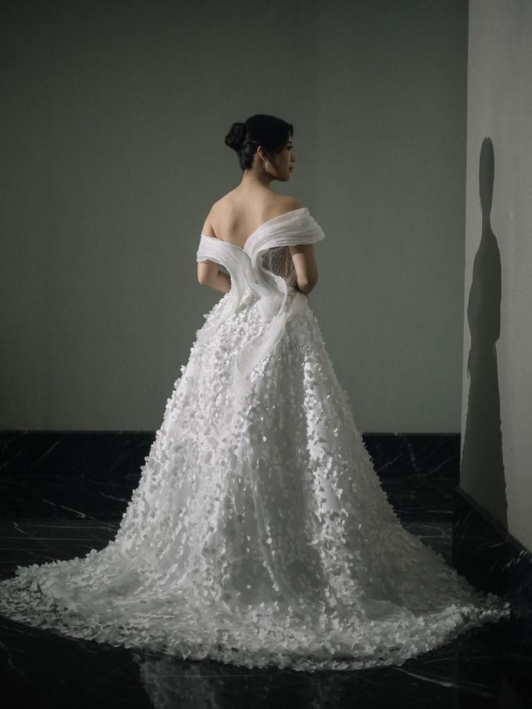 Off-shoulder ball gown with three-dimensional floral appliqué by CELRA